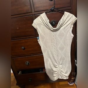 Top with gold details on sleeves, covers butt , new with tag